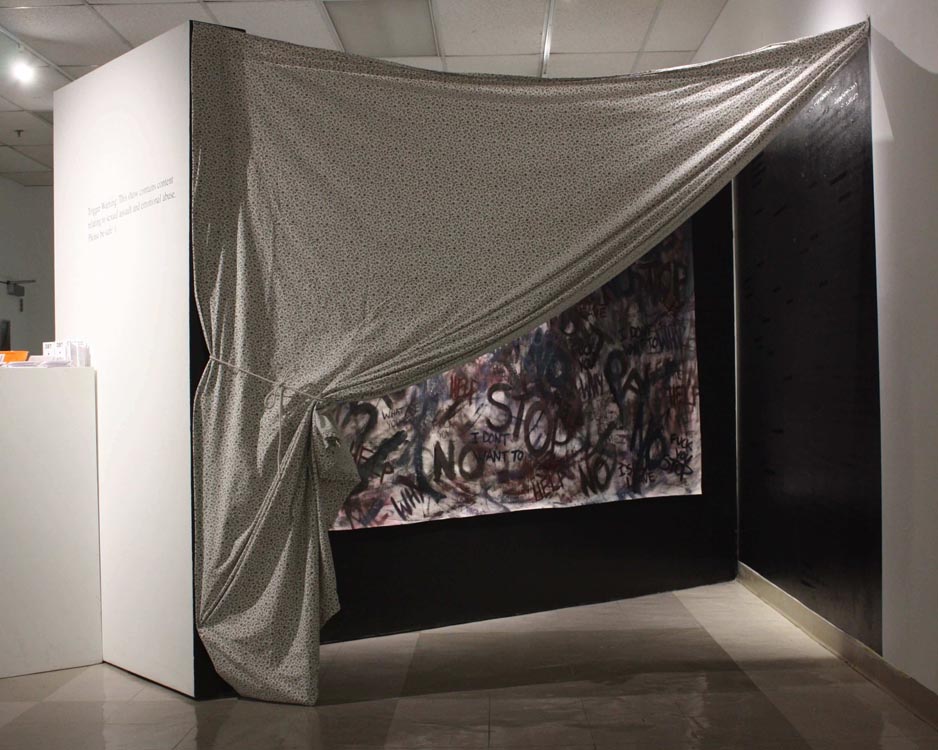 'trauma center,' a floral bedsheet hanging diagonally across the openning, showing part of the internal walls
